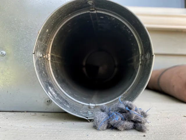Valley Falls Dryer Vent Cleaning technician using specialized equipment to clear severe dryer vent blockage in Valley Falls